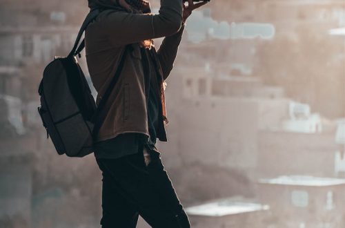 Man Holding Black Dslr Camera