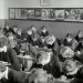 grayscale photo of people sitting on chair